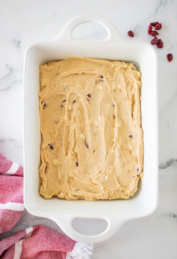 Uncooked dough in a baking dish ready to be cooked.