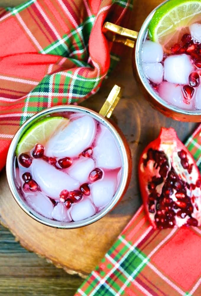 Top view of pomegranate Moscow mule with Christmas napkins on the side.