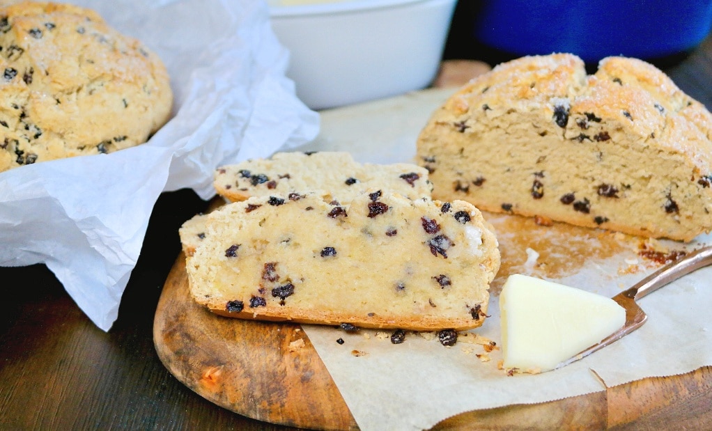 A horizontal view of sliced bread with currants. 