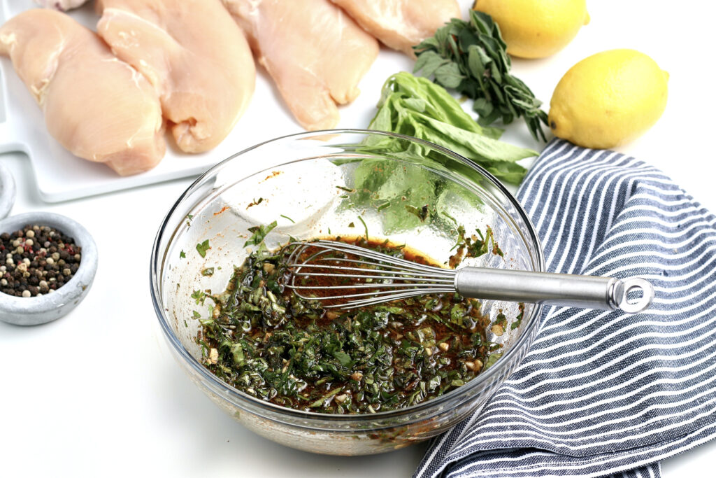 A clear bowl with homemade marinade for chicken. 