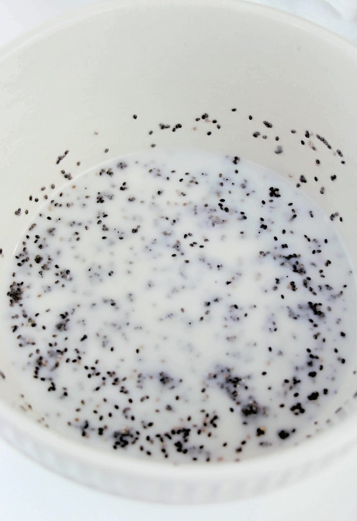 A white mixing bowl with ingredients for chia pudding.