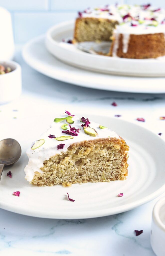 A slice of Persian cake on a white plate ready to enjoy. 