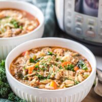 Soup in a white bowl with an Instant Pot on the side.