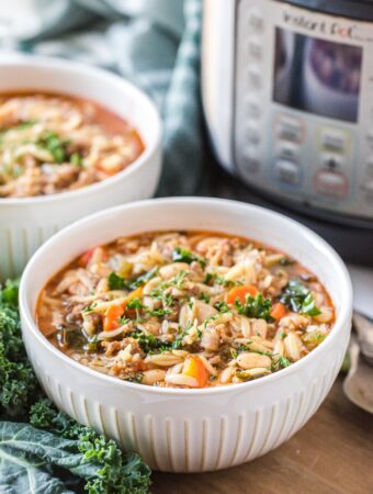 Soup in a white bowl with an Instant Pot on the side.