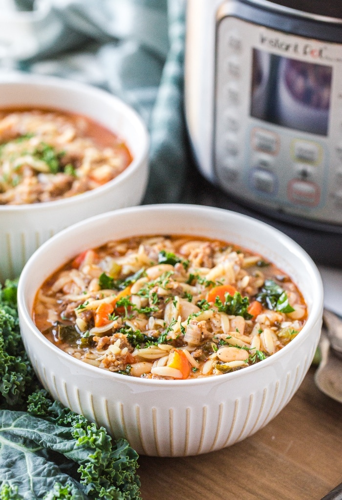 Soup in a white bowl with an Instant Pot on the side. 