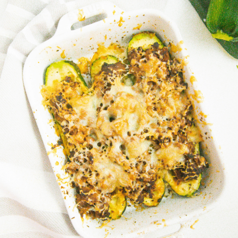 Cooked air fryer zucchini boats in a white serving dish.