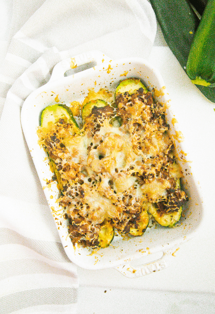 Cooked air fryer zucchini boats in a white serving dish. 