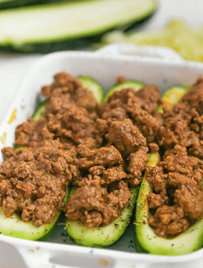 Zucchini boats stuffed with seasoned cooked hamburger meat.