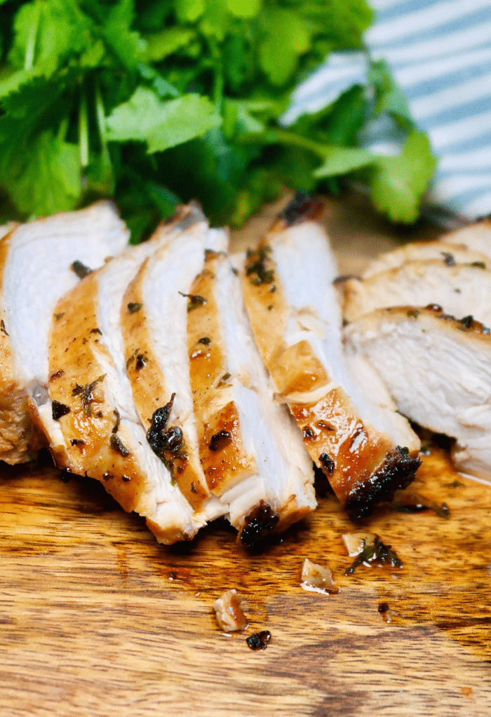 Sliced chicken breast on a cutting board. 