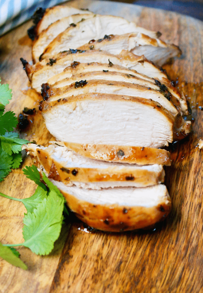 Chicken breast sliced on a cutting board ready to eat. 