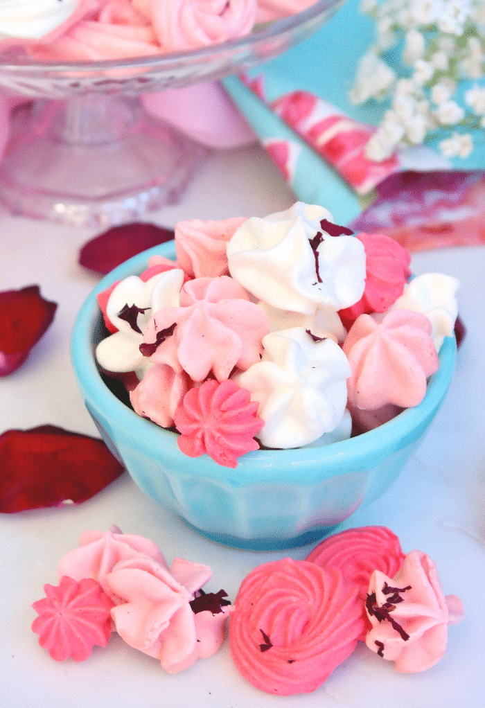 Meringue kisses in a teal bowl ready to enjoy. 