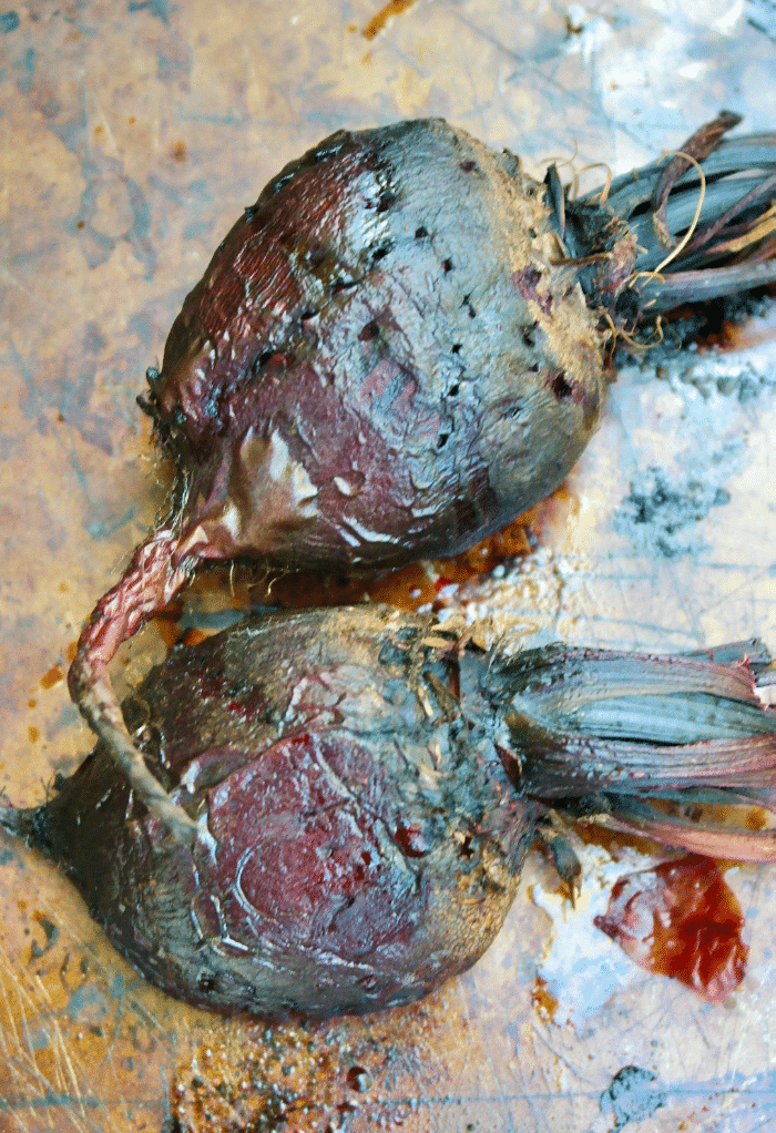 cooked roasted beets on a baking tray. 