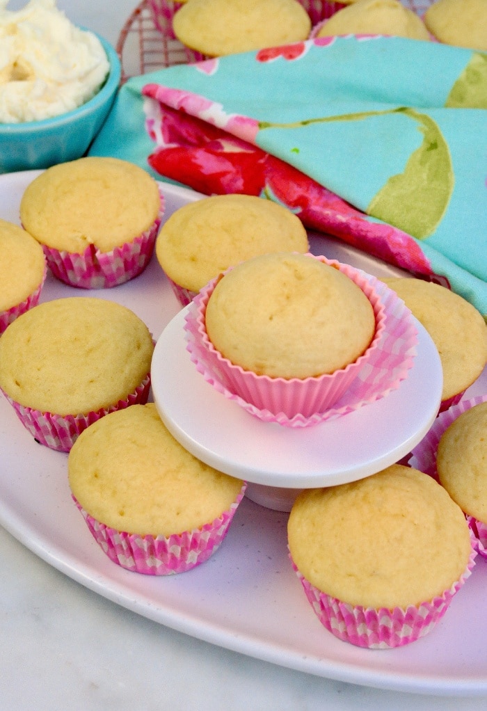 Sugar free vanilla cupcakes on a white platter. 