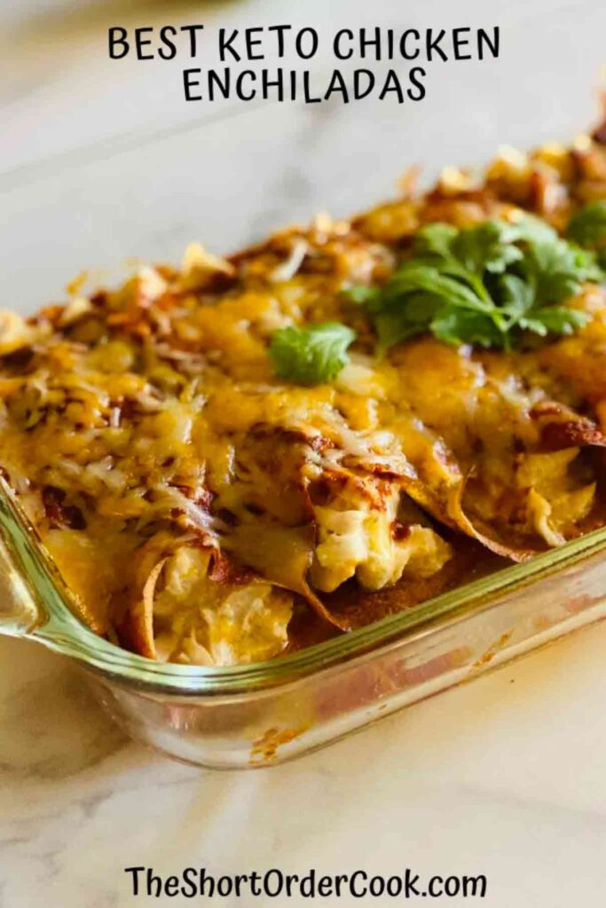 Top view of cooked chicken enchiladas topped with cheese in a clear casserole dish
