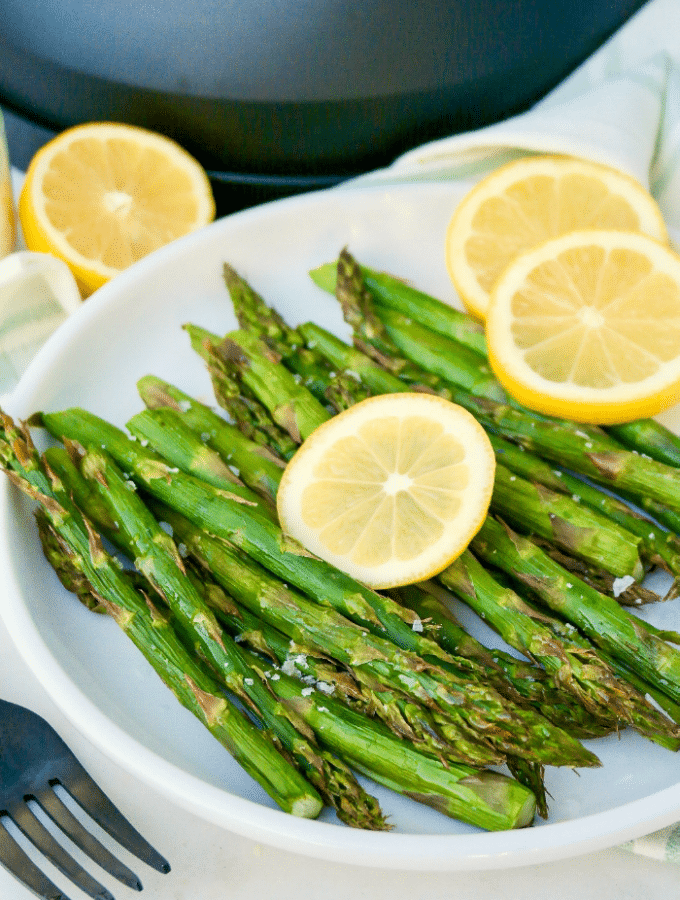 Fresh cooked air fryer asparagus topped with parmesan cheese.