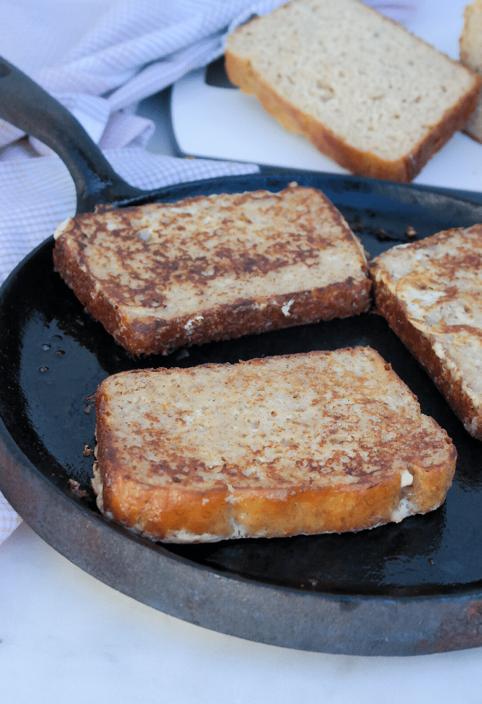 Cooking French toast on an iron skillet. 