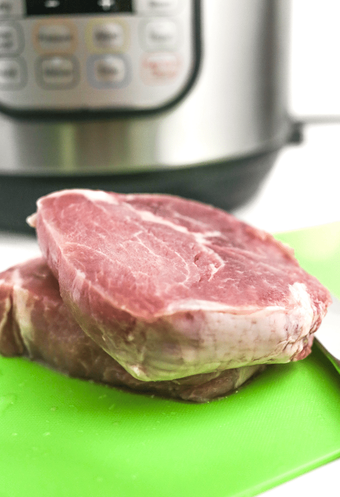 Raw pork ready to be sliced into small pieces to cook in an Instant Pot.