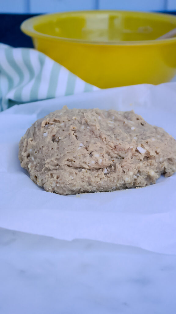 Cookie dough on white parchment paper ready to bake. 