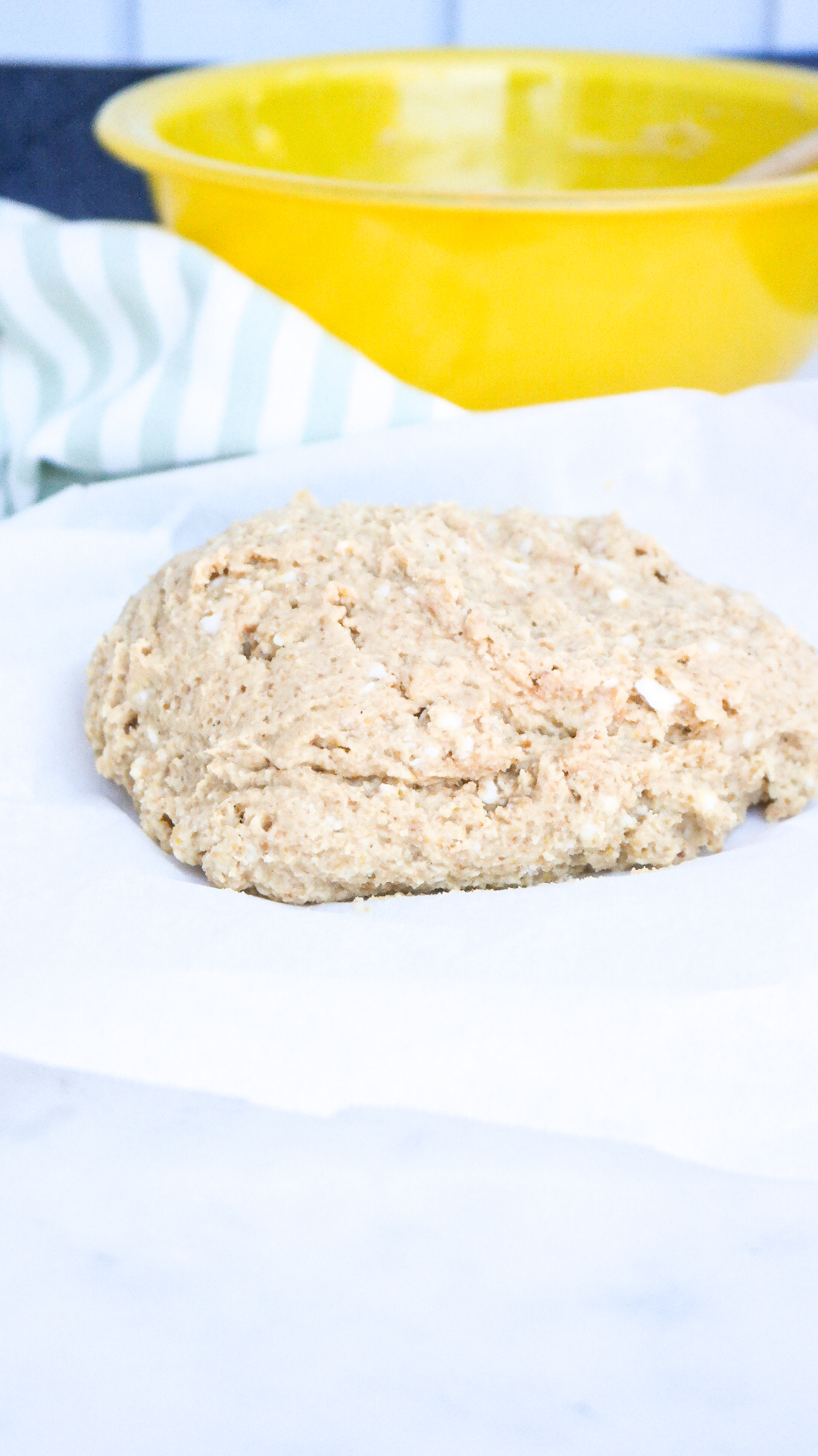 Gluten free pizza dough on parchment paper after mixed.