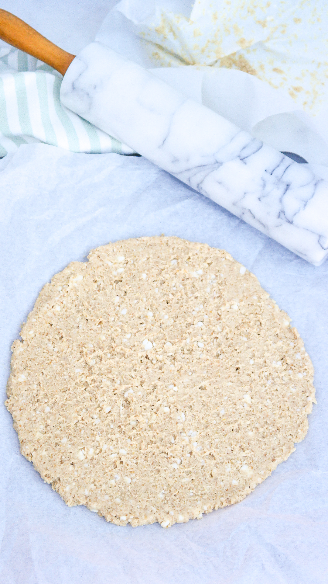 Gluten-free pizza dough rolled in the shape of a circle before baking. 