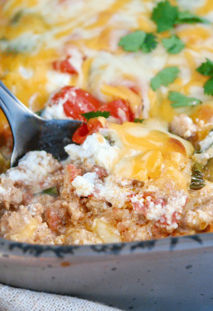 A spoonful of Keto taco casserole out of the oven ready to put on a plate to eat. 