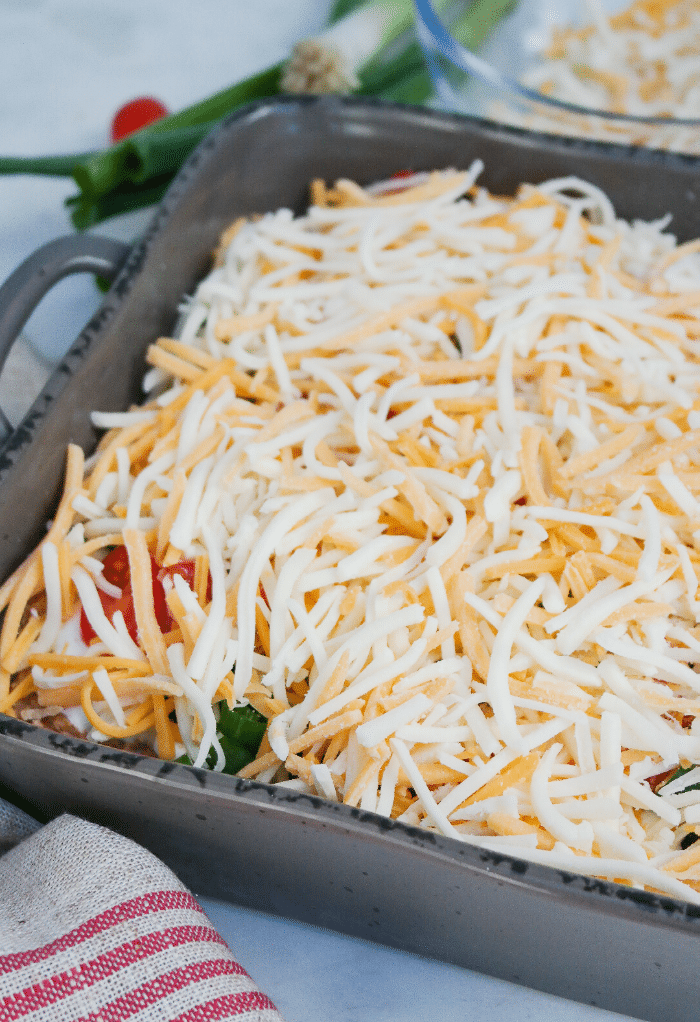 Shredded cheese on top of keto taco casserole before cooking. 