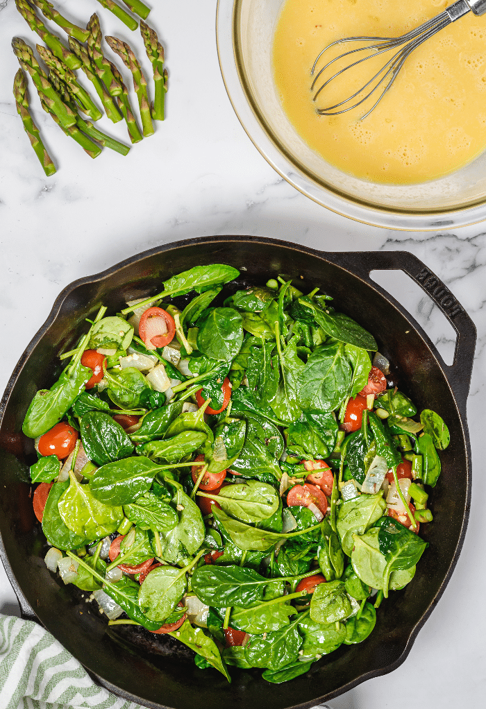 Here we add vegetables to the skillet before adding egg.