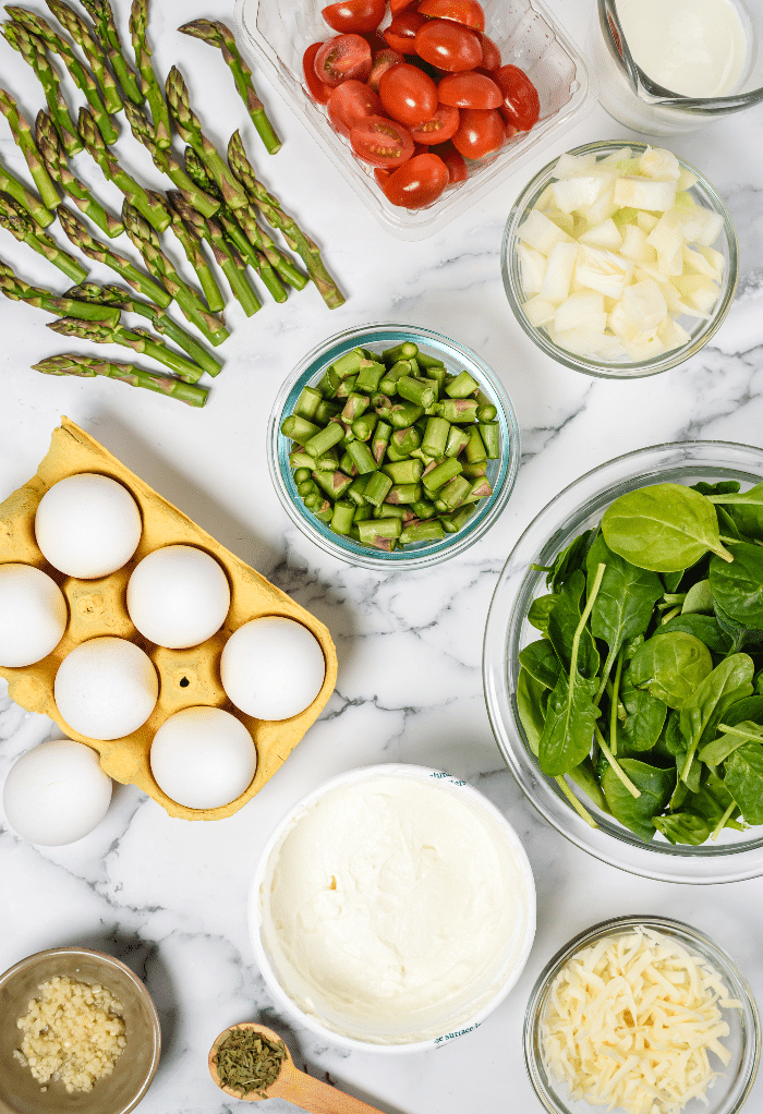 Ingredients to make a keto frittata with spinach and asparagus. 