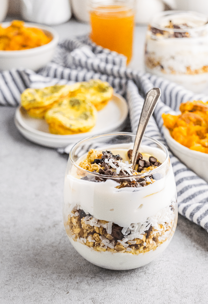 Yogurt parfait layered with granola with eggs and sweet potato mash. 