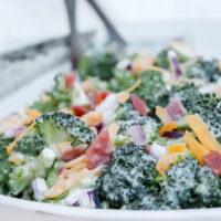 Classic broccoli salad in a white ceramic bowl.