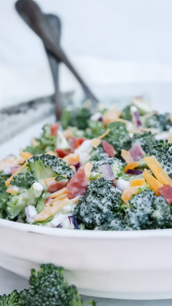 Classic broccoli salad in a white ceramic bowl.