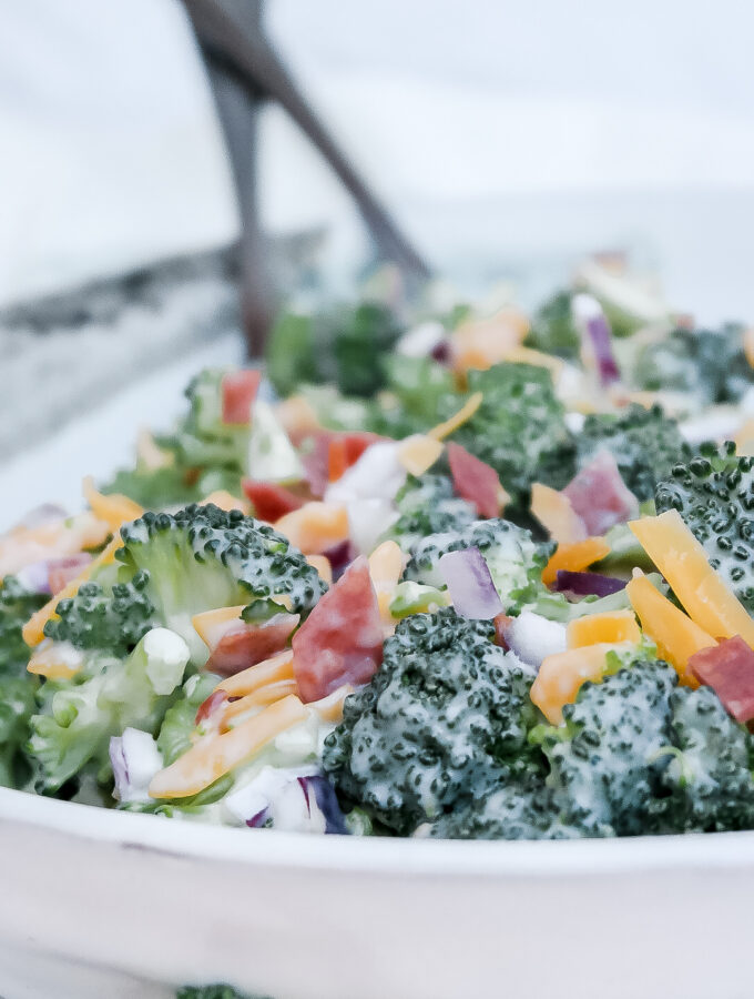 Classic broccoli salad in a white ceramic bowl.