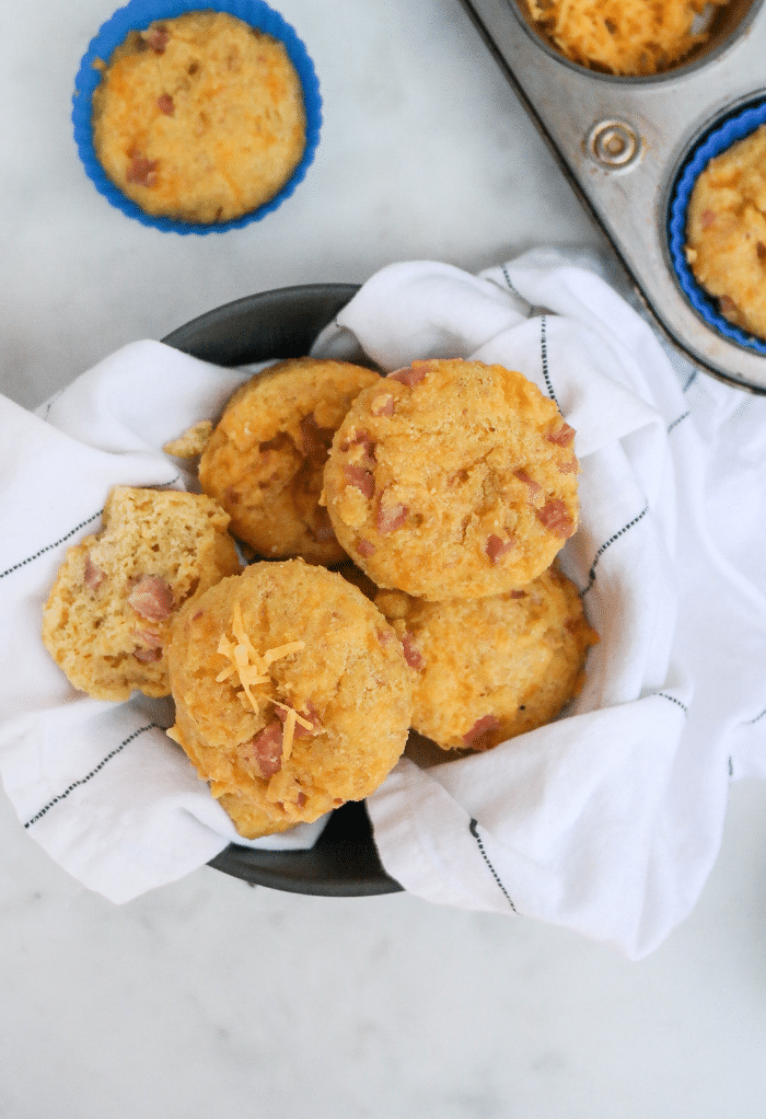 Top view of muffins in a bowl in a white linen towel. 