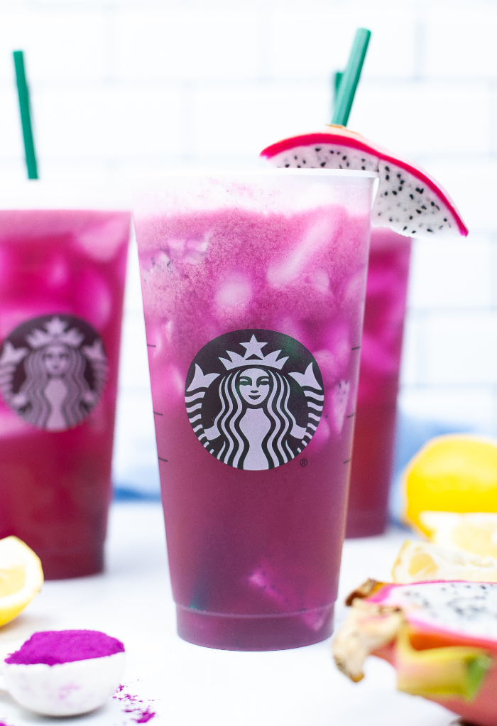 Copycat mango dragonfruit refresher beverage from Starbucks in a tall cup with a straw.