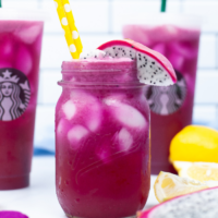 A mason jar filled with a copycat mango dragonfruit refresher beverage.