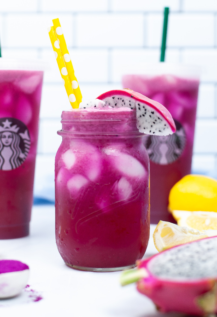 A mason jar filled with a copycat mango dragonfruit refresher beverage. 