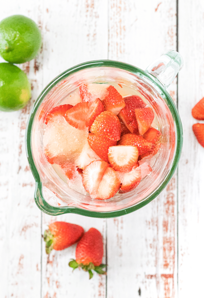 Fresh strawberries in a blender before mixing.