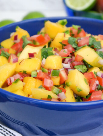 Fresh fruit salsa with mangos in a blue serving bow.