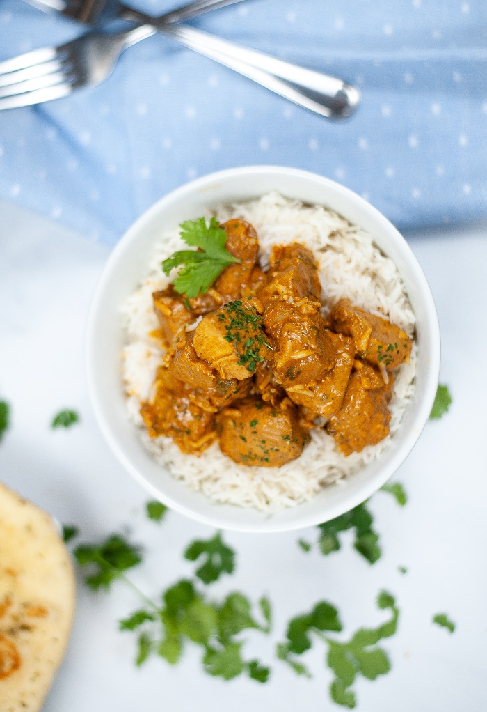 Top view of keto butter chicken in a white serving bowl. 