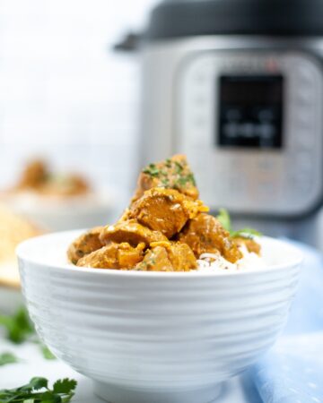 Butter chicken in a white bowl made in an Instant Pot.