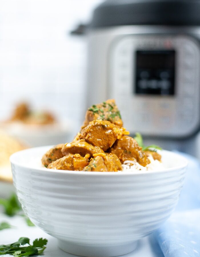 Butter chicken in a white bowl made in an Instant Pot.