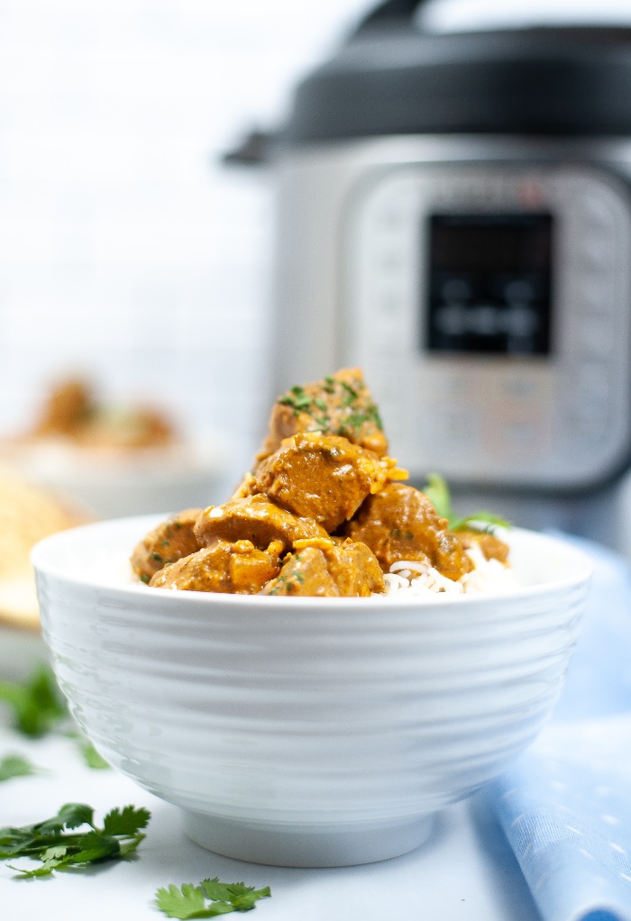 Butter chicken in a white bowl made in an Instant Pot.