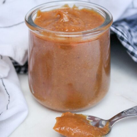 Peanut butter drizzle in a clear glass jar.