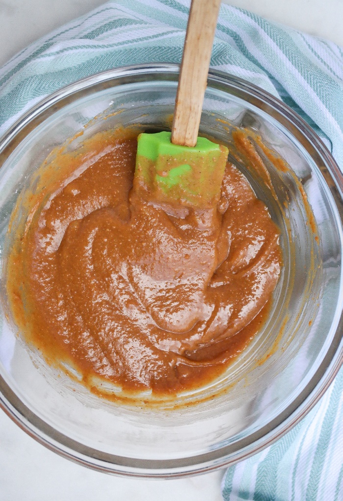 Three ingredient peanut butter sauce in a clear mixing bowl. 
