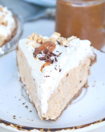 A slice of peanut butter pie on a white plate with a brown rim.