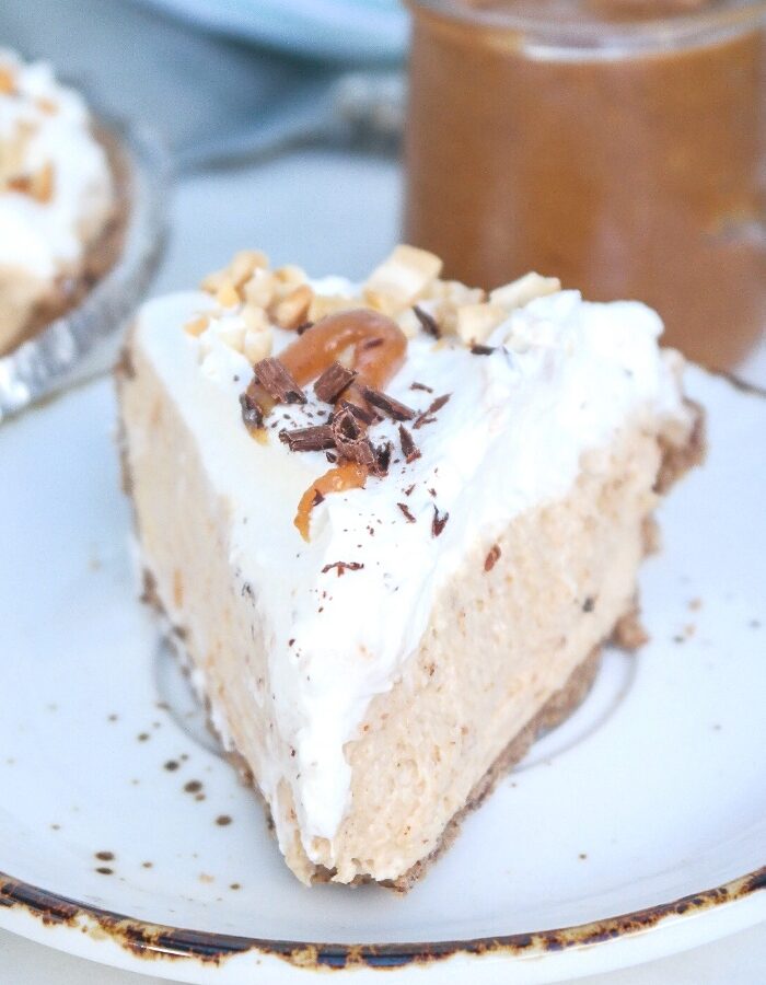 A slice of peanut butter pie on a white plate with a brown rim.