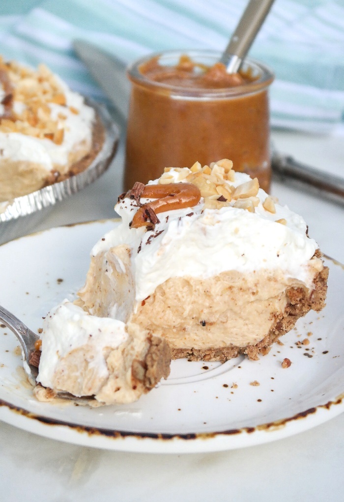 A slice of no bake pie on a white plate with a brown rim. 