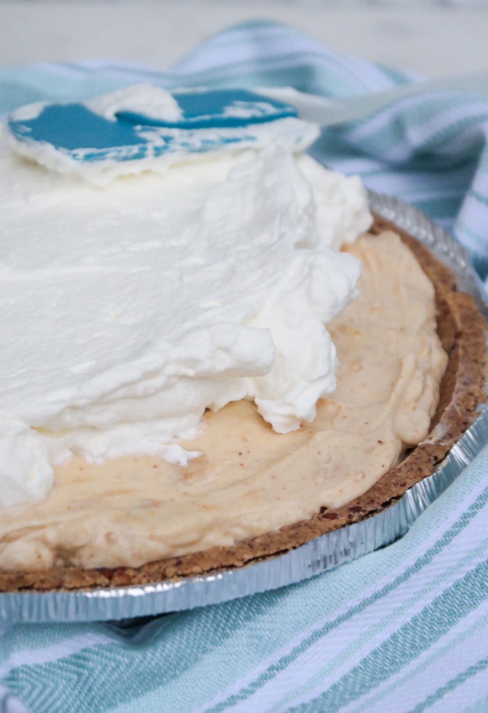 Fresh whipped cream over a peanut butter pie.