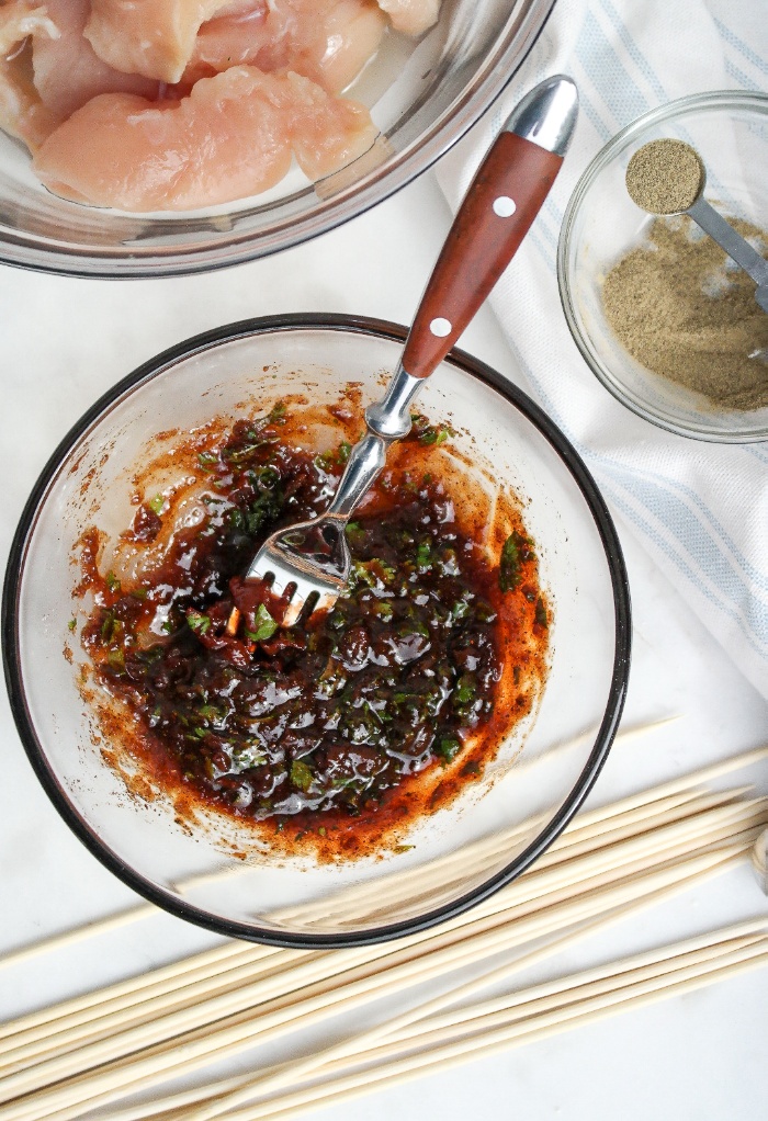 Chipotle chicken marinade in a clear mixing bowl.