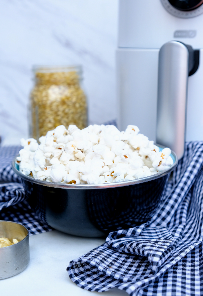 Air fryer popcorn in a black serving bowl. 